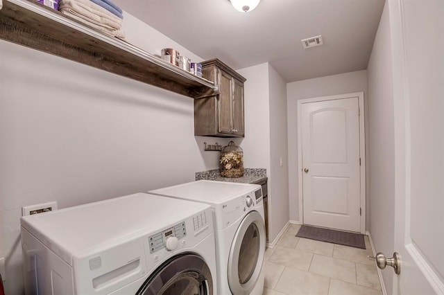 washroom with cabinet space, light tile patterned flooring, separate washer and dryer, baseboards, and visible vents
