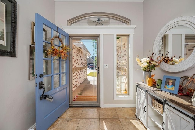 entryway featuring light tile patterned floors and baseboards