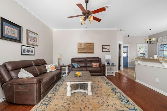 living room featuring visible vents, baseboards, ceiling fan with notable chandelier, and wood finished floors