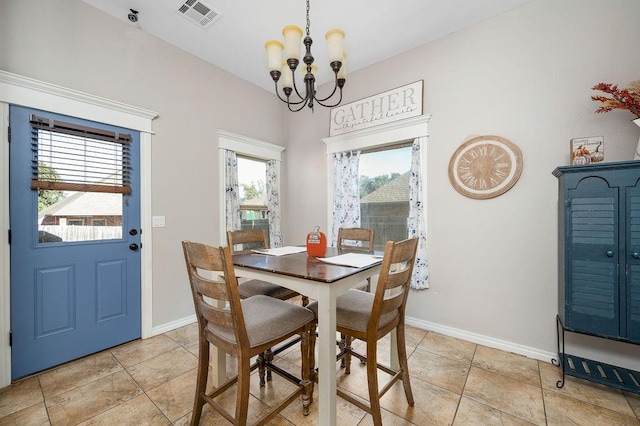 dining room with visible vents, baseboards, and a notable chandelier