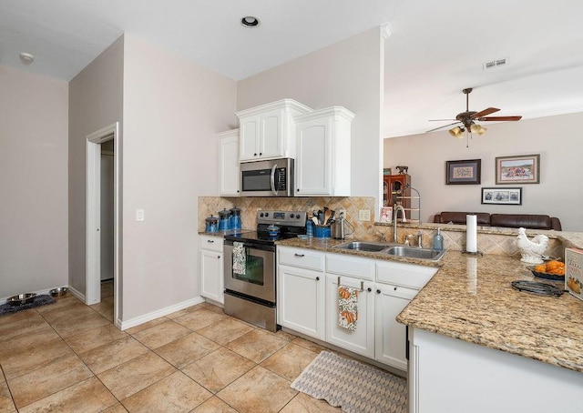 kitchen with a ceiling fan, visible vents, appliances with stainless steel finishes, tasteful backsplash, and a sink