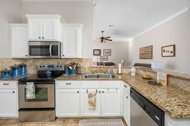 kitchen featuring ceiling fan, white cabinets, light stone counters, a sink, and appliances with stainless steel finishes