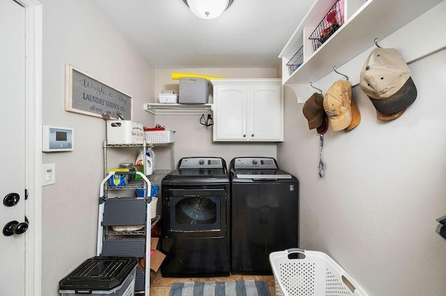 clothes washing area with cabinet space and washing machine and clothes dryer
