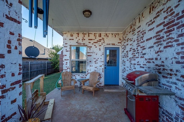 view of patio featuring fence and grilling area