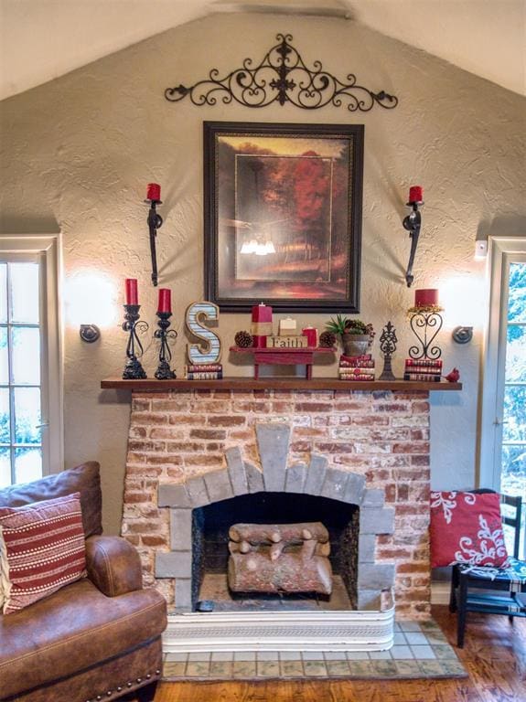 1818 N Union Ave, Shawnee, OK 74804 - detailed view of wood finished floors, a textured wall, and a stone fireplace