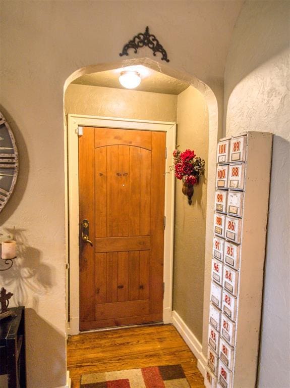 1818 N Union Ave, Shawnee, OK 74804 - entryway with wood finished floors, arched walkways, and baseboards