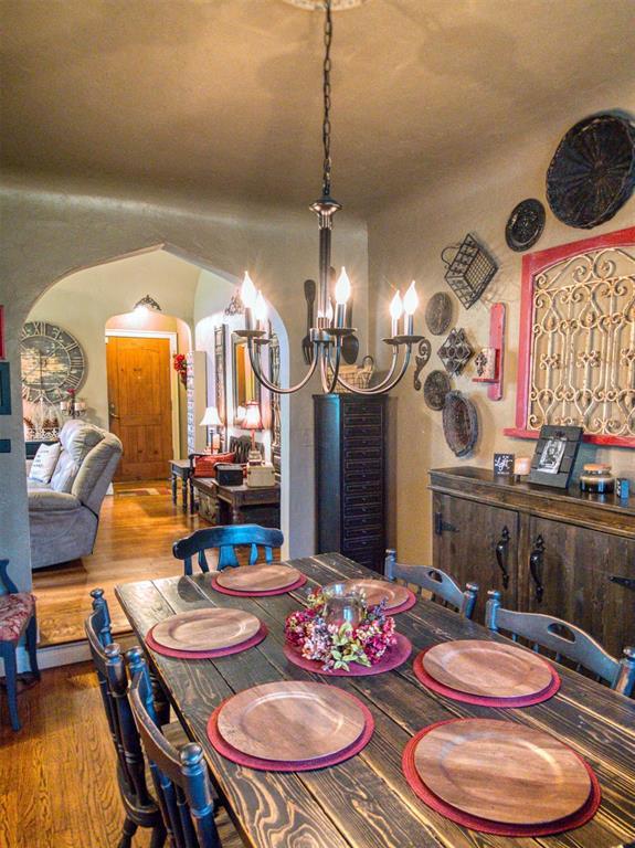 1818 N Union Ave, Shawnee, OK 74804 - dining area with a chandelier, wood finished floors, and arched walkways