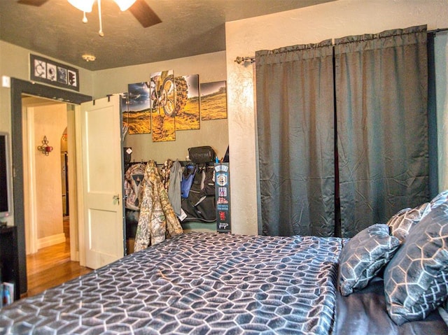 1818 N Union Ave, Shawnee, OK 74804 - bedroom featuring arched walkways, wood finished floors, and ceiling fan