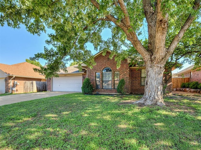 1621 Park View Pl, Edmond, OK 73003 - view of front of house with a front lawn, fence, brick siding, concrete driveway, and an attached garage