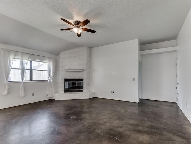1621 Park View Pl, Edmond, OK 73003 - unfurnished living room featuring ceiling fan, finished concrete flooring, a brick fireplace, a textured ceiling, and lofted ceiling