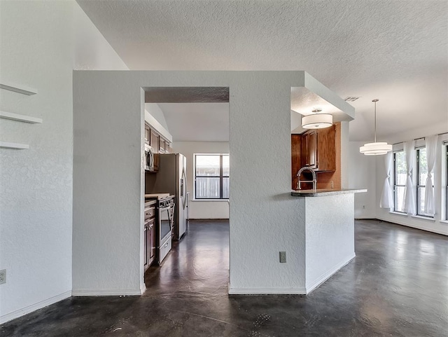 1621 Park View Pl, Edmond, OK 73003 - kitchen featuring brown cabinets, a textured wall, stainless steel appliances, and concrete floors