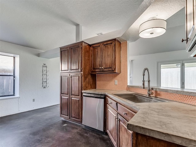 1621 Park View Pl, Edmond, OK 73003 - kitchen featuring decorative backsplash, a textured ceiling, finished concrete floors, a sink, and dishwasher