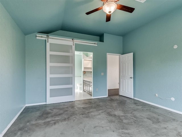 1621 Park View Pl, Edmond, OK 73003 - unfurnished bedroom with finished concrete flooring, baseboards, a barn door, and lofted ceiling