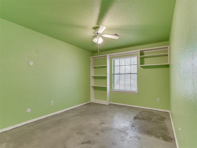 1621 Park View Pl, Edmond, OK 73003 - spare room featuring a textured wall, baseboards, a textured ceiling, unfinished concrete flooring, and a ceiling fan