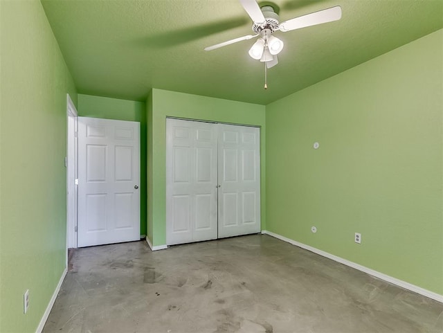 1621 Park View Pl, Edmond, OK 73003 - unfurnished bedroom featuring concrete flooring, baseboards, a ceiling fan, and a closet