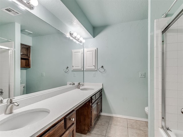 1621 Park View Pl, Edmond, OK 73003 - bathroom with a sink, toilet, tile patterned floors, a shower with door, and visible vents
