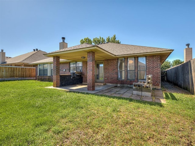 1621 Park View Pl, Edmond, OK 73003 - rear view of house featuring brick siding, a patio, a fenced backyard, and a lawn