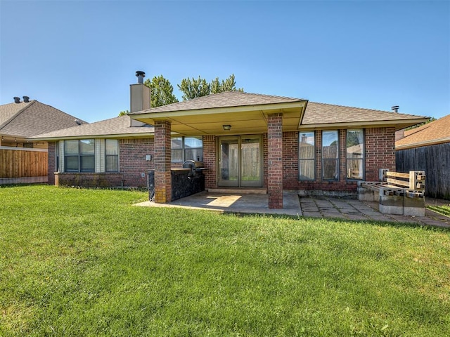 1621 Park View Pl, Edmond, OK 73003 - back of house with a patio, a lawn, fence, and a chimney