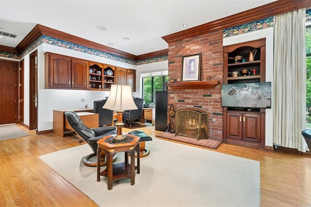 4200 Oakdale Farm Cir, Edmond, OK 73013 - living area with a fireplace, crown molding, light wood-style flooring, and visible vents