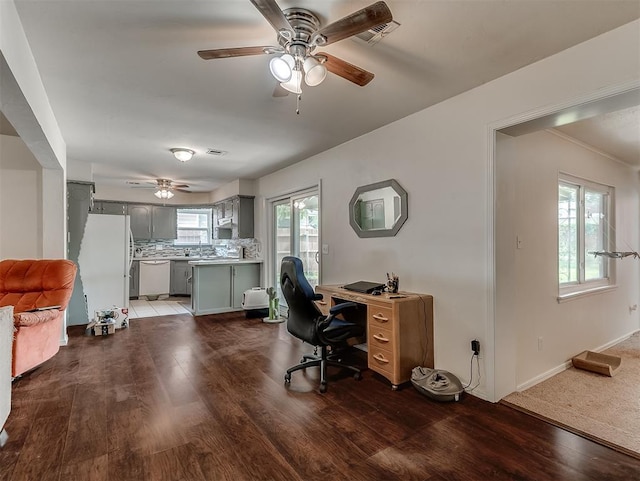 office space featuring ceiling fan, visible vents, and wood finished floors