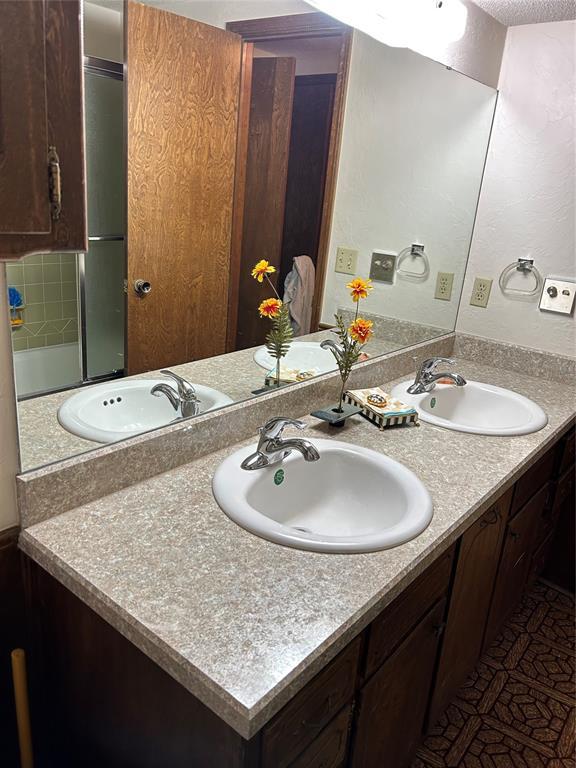 bathroom featuring a sink and double vanity