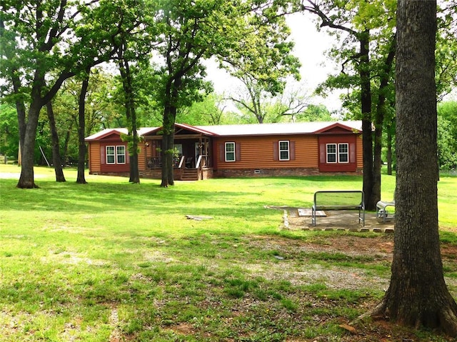 exterior space featuring a front yard, faux log siding, and covered porch