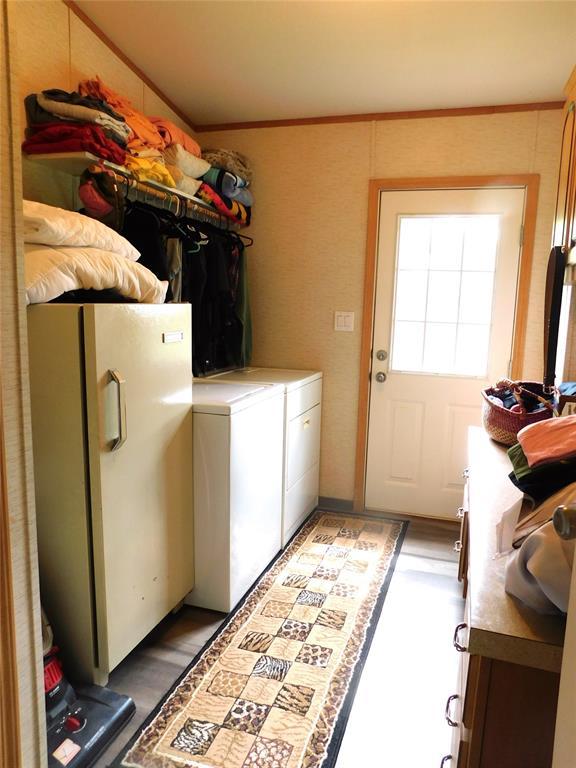 laundry room with light wood-style floors, washer and clothes dryer, and laundry area