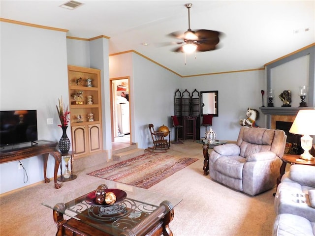carpeted living area with a fireplace, crown molding, a ceiling fan, visible vents, and baseboards
