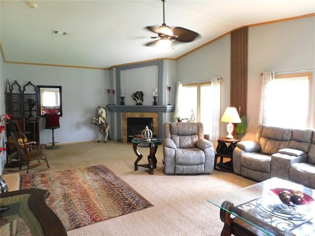 living area with visible vents, ceiling fan, vaulted ceiling, carpet, and a tiled fireplace