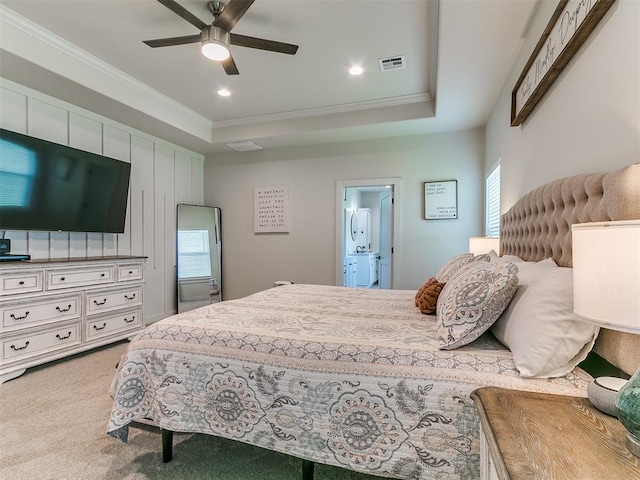bedroom with carpet floors, ornamental molding, a tray ceiling, and visible vents