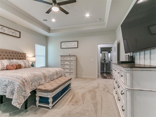bedroom featuring a raised ceiling, ornamental molding, light carpet, and visible vents