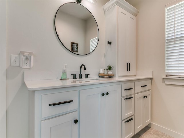 bathroom with vanity and baseboards