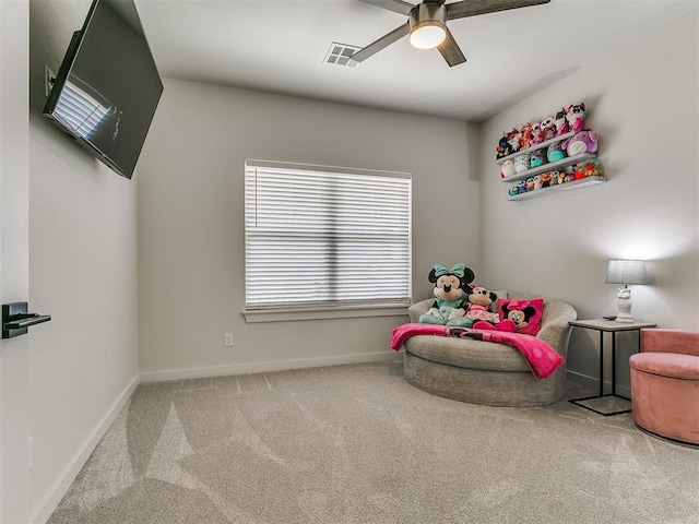 living area featuring baseboards, a ceiling fan, carpet flooring, and visible vents