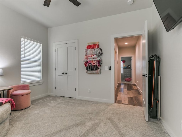 carpeted bedroom featuring a ceiling fan, baseboards, and a closet