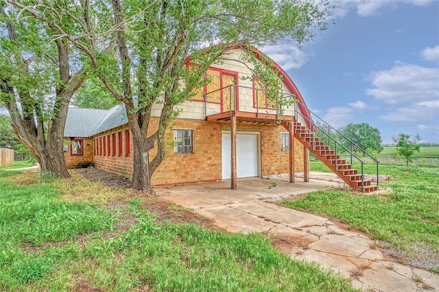 22676 N Rte 66, Clinton, OK 73601 - back of house with a garage, stairs, and concrete driveway