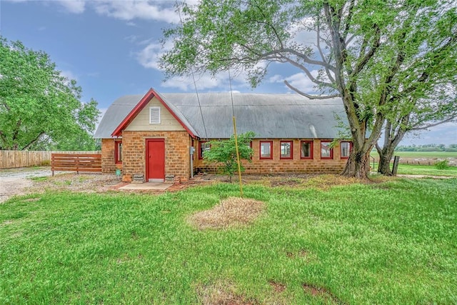 22676 N Rte 66, Clinton, OK 73601 - view of front facade with fence, metal roof, and a front lawn