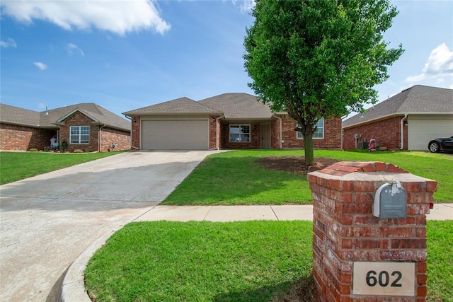 single story home with brick siding, a garage, driveway, and a front lawn
