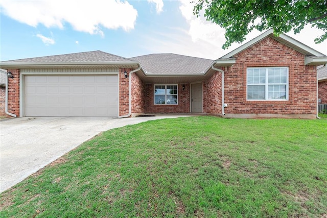 single story home featuring an attached garage, a front lawn, driveway, and brick siding