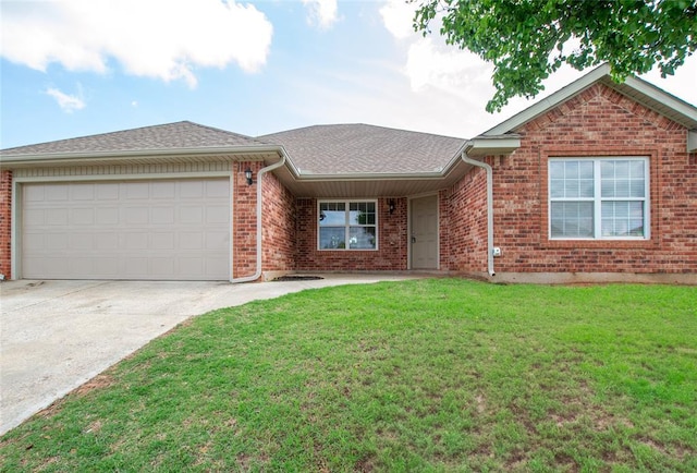 ranch-style house with roof with shingles, an attached garage, brick siding, a front yard, and concrete driveway