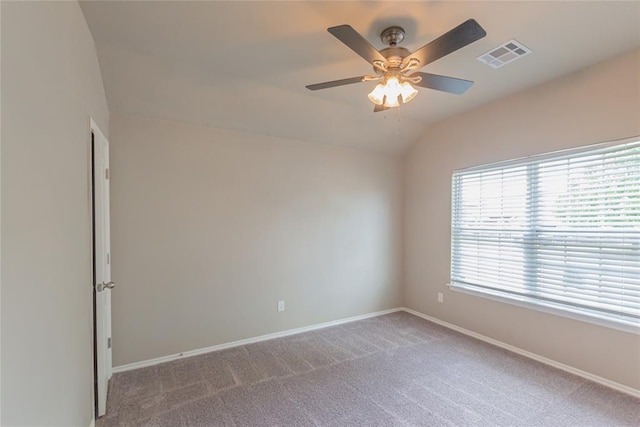 unfurnished room featuring a ceiling fan, visible vents, vaulted ceiling, baseboards, and carpet flooring