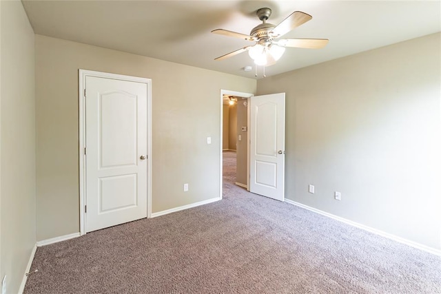 unfurnished bedroom with baseboards, ceiling fan, and carpet