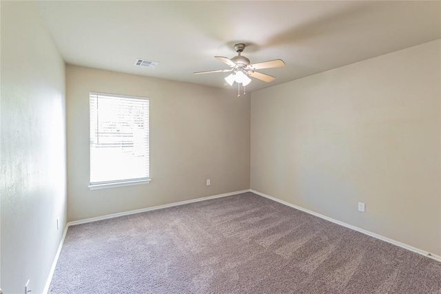 carpeted empty room featuring visible vents, baseboards, and ceiling fan