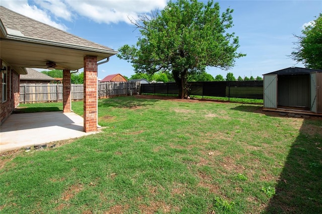 view of yard with a patio, a fenced backyard, a shed, and an outdoor structure
