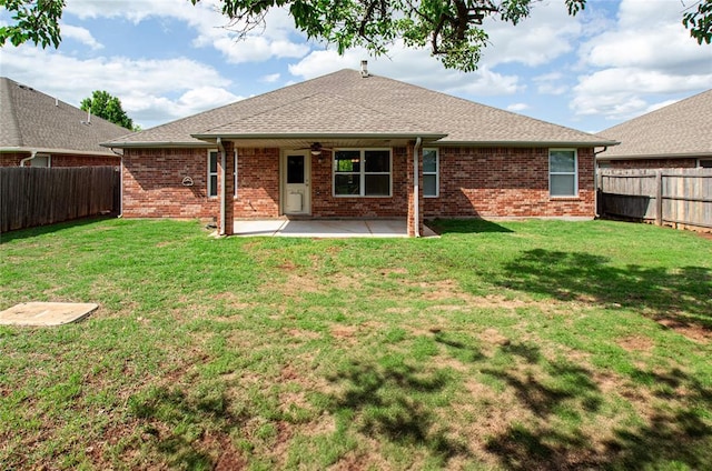 rear view of property with brick siding, a ceiling fan, a fenced backyard, and a patio area