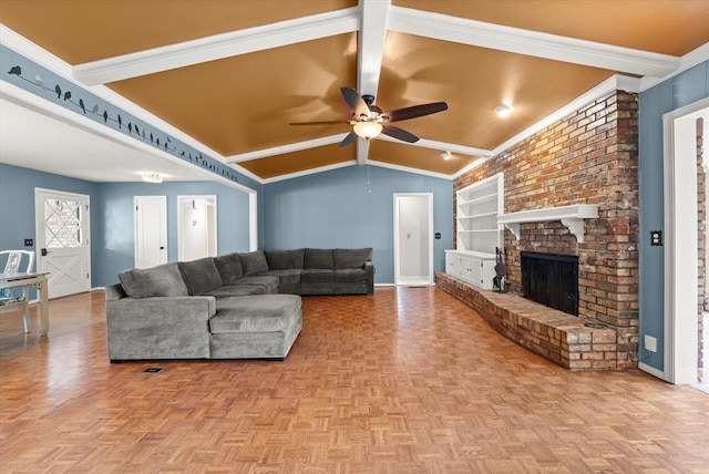 living room featuring a ceiling fan, a brick fireplace, built in shelves, baseboards, and vaulted ceiling with beams