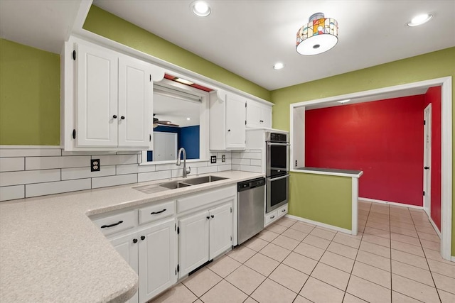 kitchen featuring a sink, appliances with stainless steel finishes, decorative backsplash, and light countertops