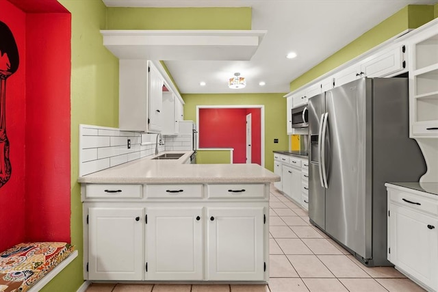 kitchen featuring recessed lighting, a sink, white cabinetry, and appliances with stainless steel finishes