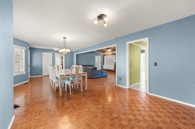 dining room with baseboards, a ceiling fan, and visible vents