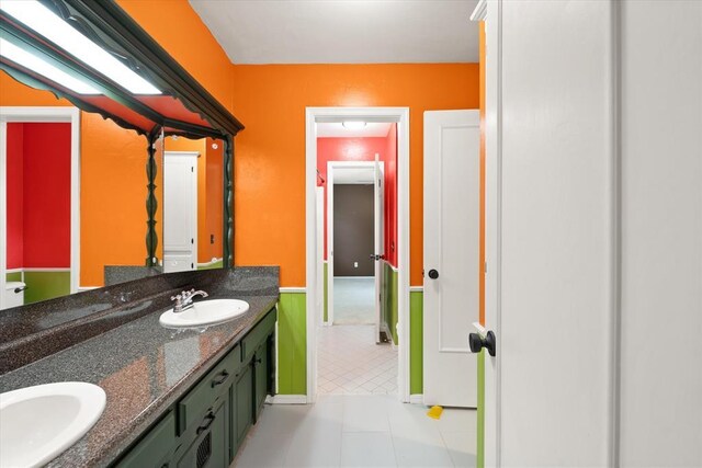 bathroom featuring a sink, tile patterned floors, and double vanity