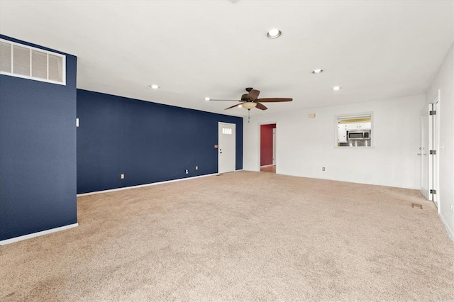 carpeted spare room with ceiling fan, recessed lighting, and visible vents